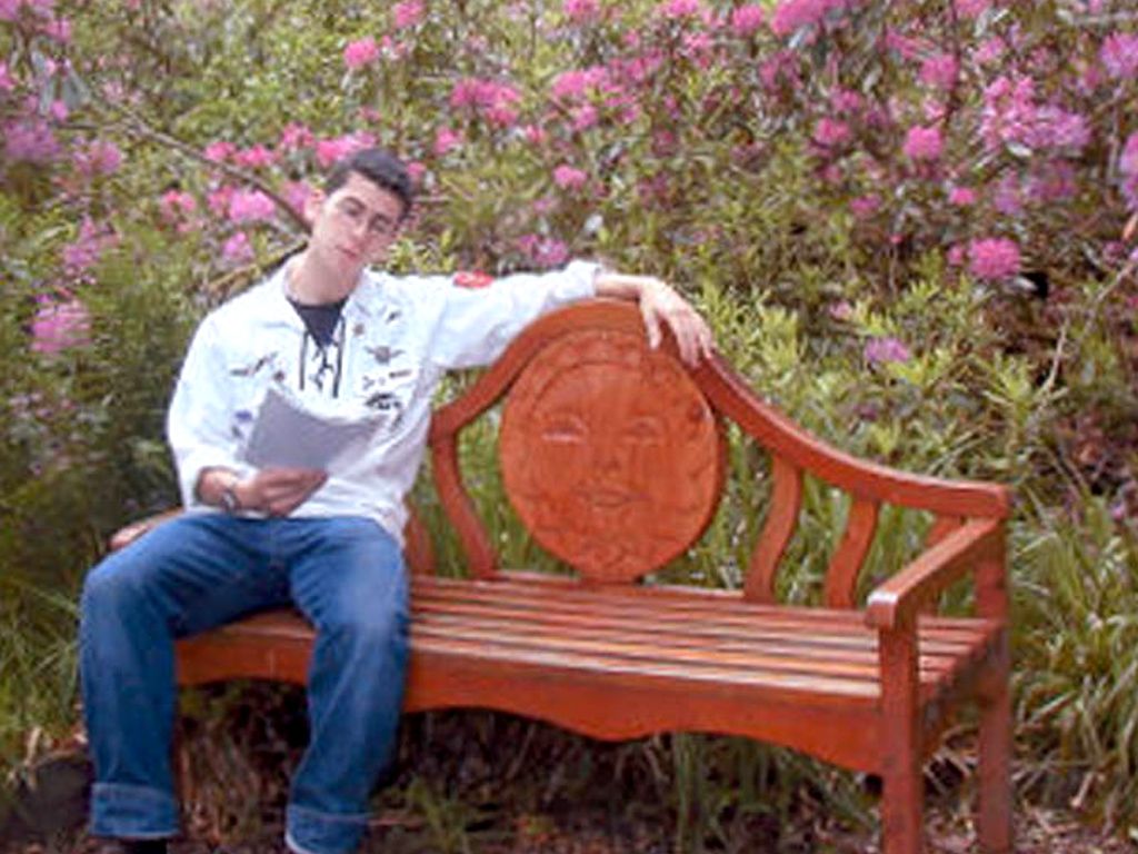 Yoni on a bench in the flower garden